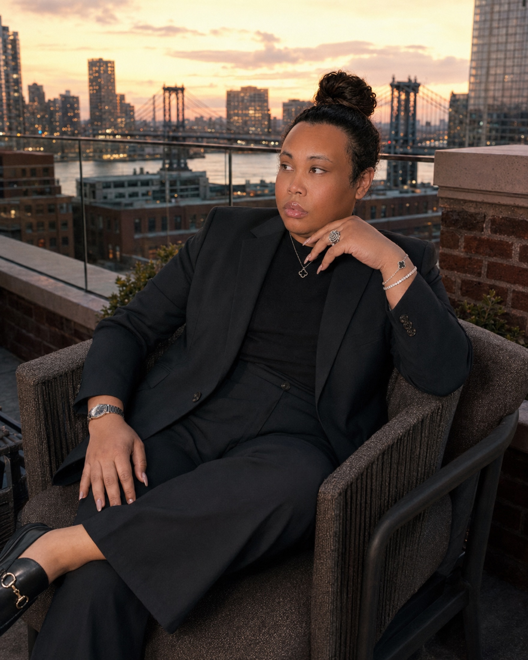 Daniel Lee Hue seated on a New York rooftop at sunset